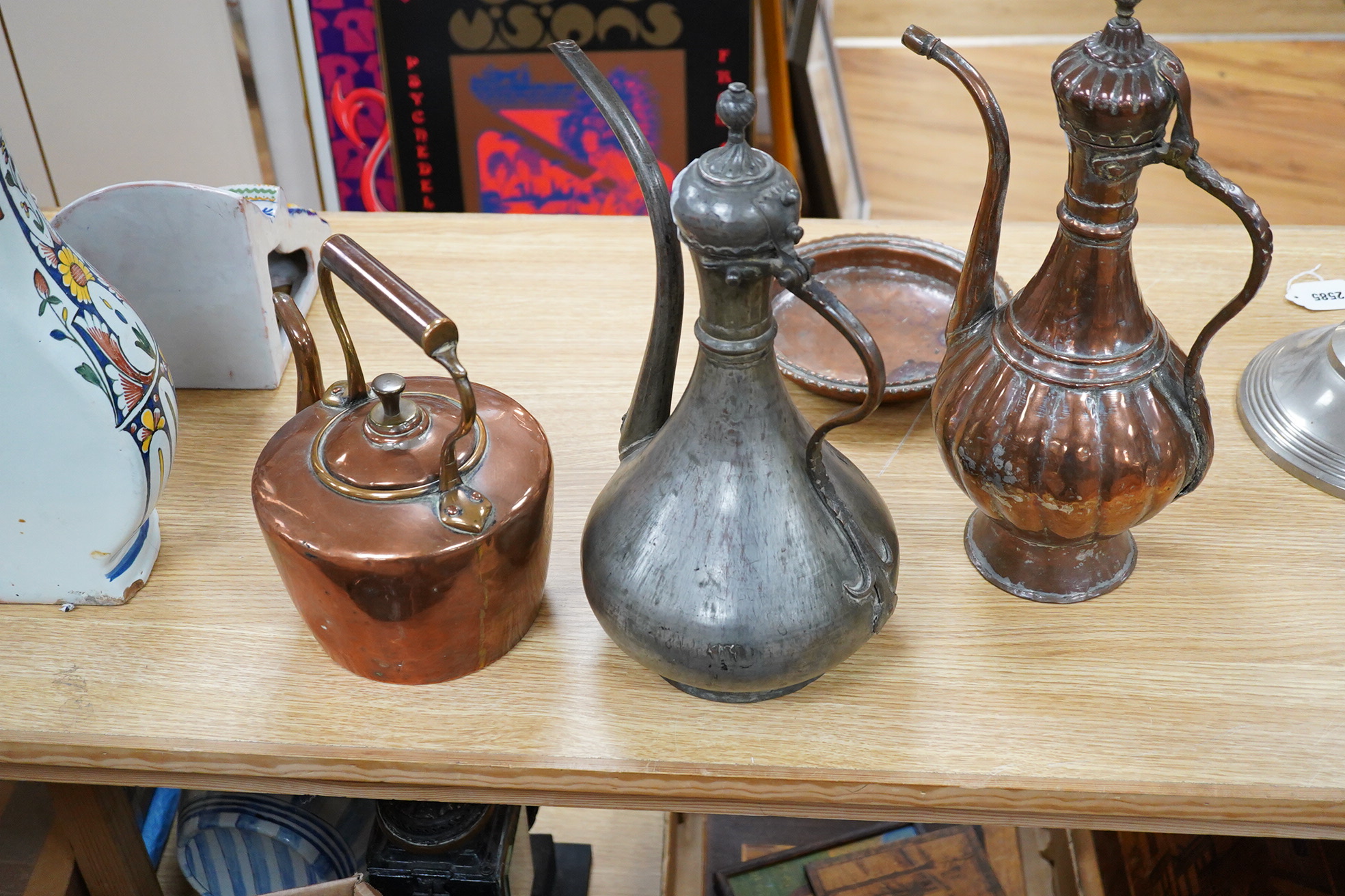 Two Middle eastern tinned copper coffee pots ‘Dallah’ a similar dish and a European copper kettle, tallest 41cm high